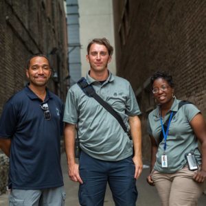 three people in an alley